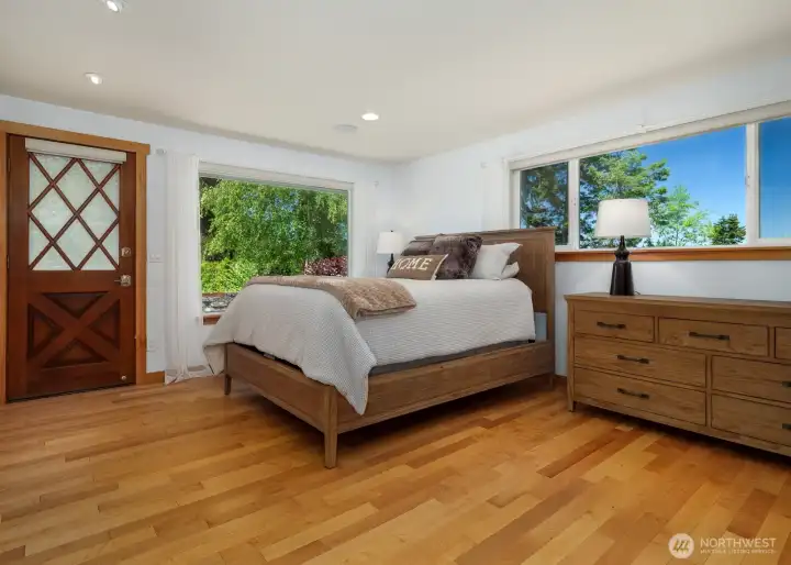 Primary Bedroom, exterior door to private patio. Maple Hardwoods throughout.