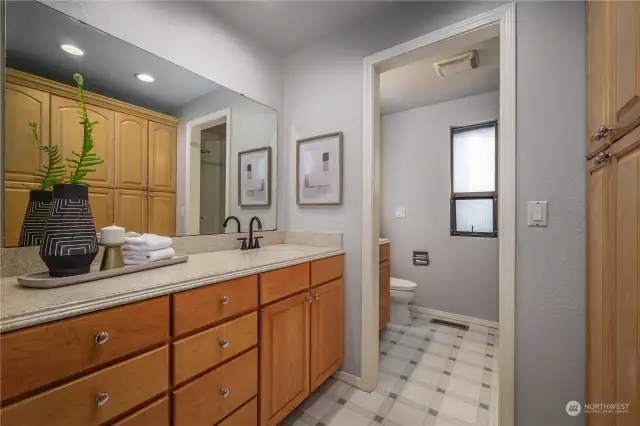 And the ensuite primary bathroom features dual sinks, Corian countertops, a walk-in shower, commode and plenty of extra storage.