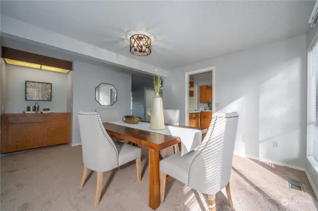 The dining room also features a stylish dry bar, perfect for crafting cocktails and entertaining guests before dinner. Here you can see the dining room's proximity to the kitchen.