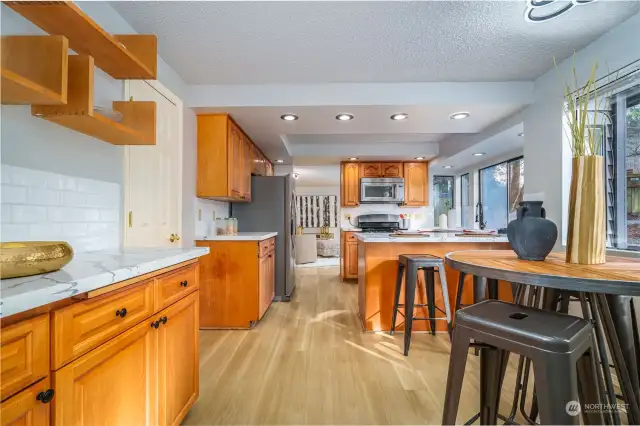 This beautiful kitchen boasts new quartz countertops, subway tile backsplash, new LVP flooring and a new refrigerator.