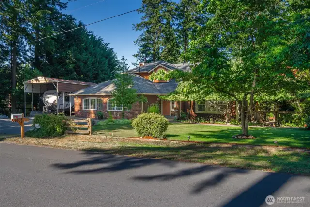 Looking for a stately brick accented 5-bedroom home on a quiet shady street on the side of town where everyone still has beautiful tall trees instead of bare lots almost touching each other? Welcome to 183rd, a quiet cul-de-sac community where bike riding and actually playing in the street is safe. You can see the large covered RV parking area to the left of the home complete with hookups and an RV dump connected to the sewer.