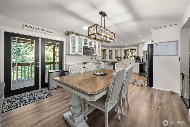 Lovely, huge french doors leading to the full-length back deck, perfect for viewing the deer wandering through the yard (there's an opening in the back fence by design to feed the deer and allow them to come through the yard. As with the rest of the house, beautiful LVP flooring is shown here.