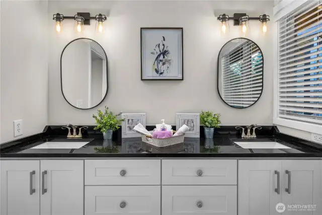 Stunning main floor bathroom serves the two main floor bedrooms with plenty of space and double granite vanities.