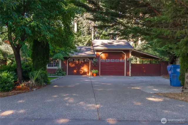 Large shop with another covered wing shown to the right, and ample parking in the driveways on either side of the house. The shop also has a sink in it to wash up while you're tinkering with your projects.