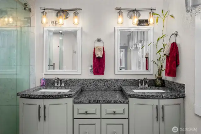 The primary bath has double granite vanities with lots of cabinet space.