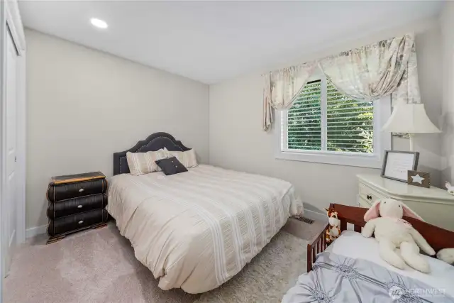 One of the 2 upstairs secondary bedrooms, overlooking the private wooded backyard area.