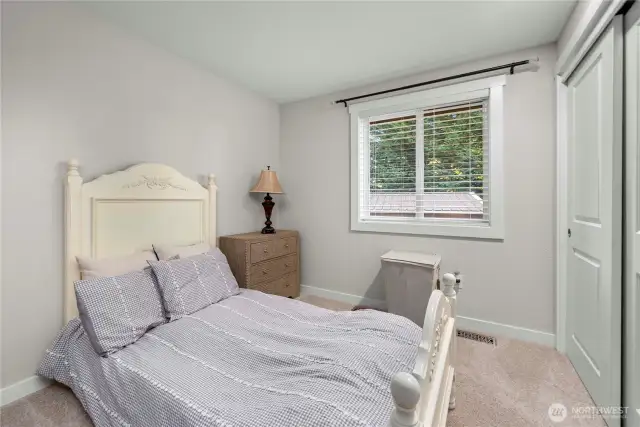 The second of the 3 upstairs bedrooms, also looking out over private wooded space.