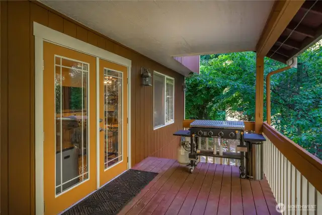 Here's a closer view of just one side of the private covered deck with the french doors leading to the kitchen and dining areas.