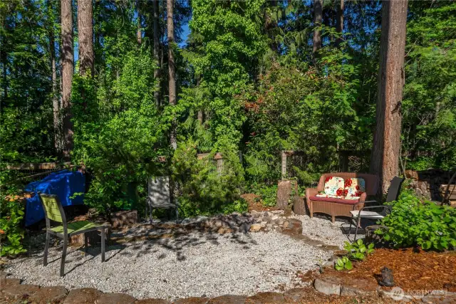 Here's another "camping at home feel" outdoor space to have a campfire or just sit and enjoy being near the two-acre wooded lot behind you that's landlocked.  It's like owning a whole extra parcel without the expense.