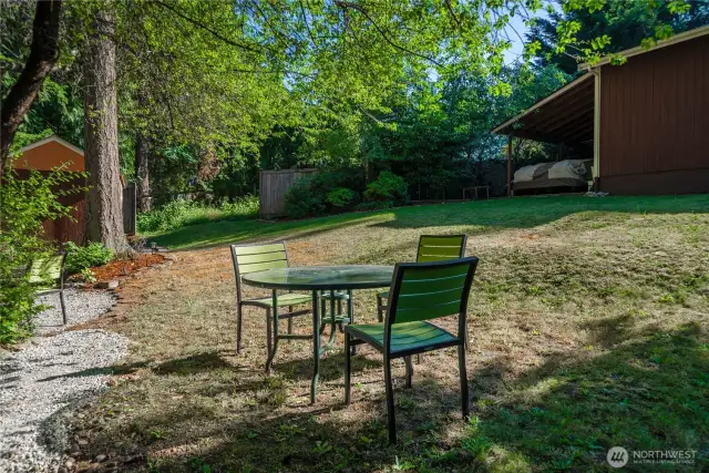 Here's another outdoor enjoyment area and also shows a rear view of the covered parking/storage area on the side of the detached shop.