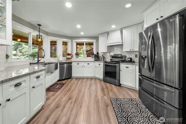Dream kitchen, anyone? This completely remodeled kitchen boasts gorgeous floors, cabinetry and granite countertops, complete with a huge farm-style sink. The stove is plumbed for propane or electric.