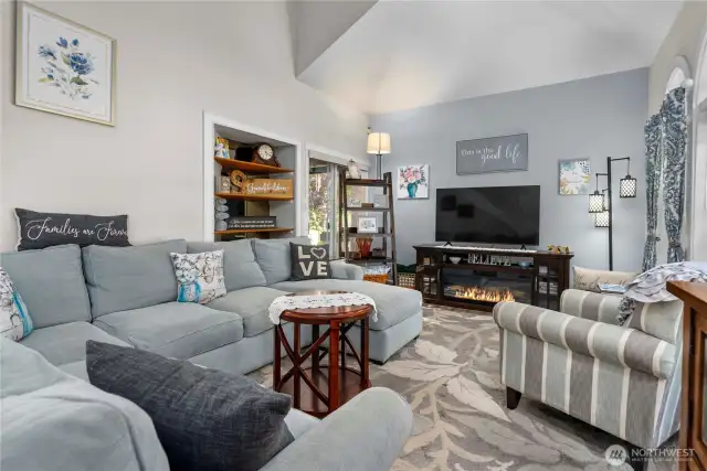 Beautiful front living room as you enter the house, with soaring ceilings, ample natural light and custom blinds.