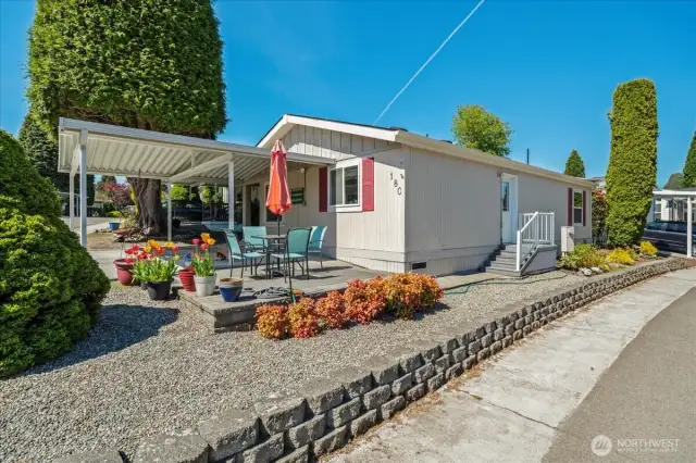 Side view of the home on it's corner lot, nicely landscaped.