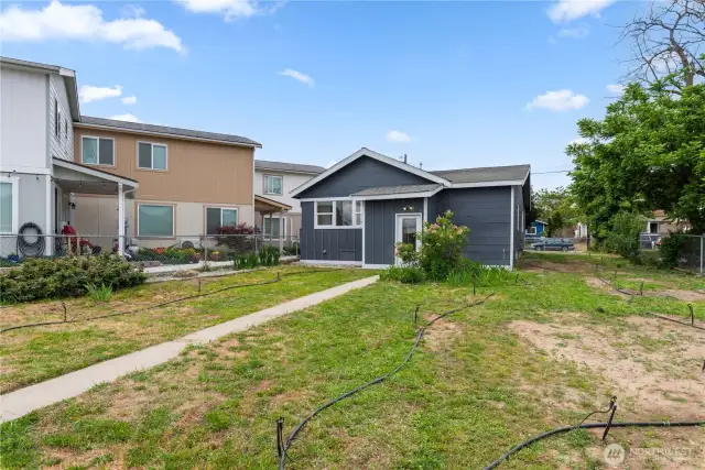 Side yard for gardening or play area.