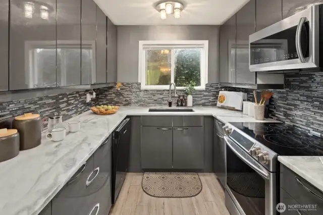Stainless Steel appliances, Streamlined cabinetry, Granit Counter tops.  Plenty of storage and pantry to the right near the laundry nook.