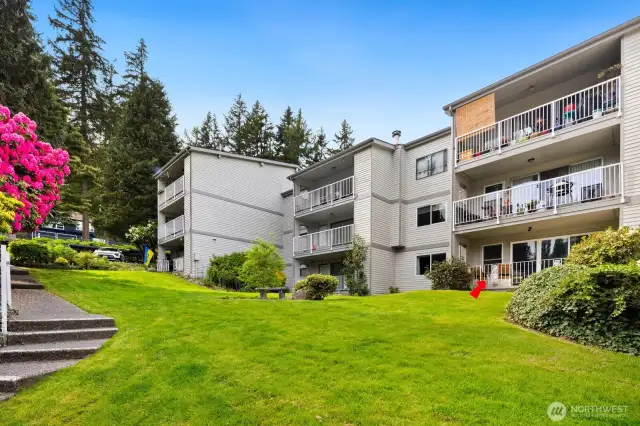 Unit is nestled privately on the ground level to the right.  Beautiful vast back yard is yours to enjoy and the steps are an easy access to the clubhouse.