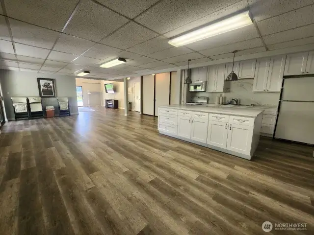 Recently updated clubhouse  kitchen and expanded event room opens to the media and out to the pool.