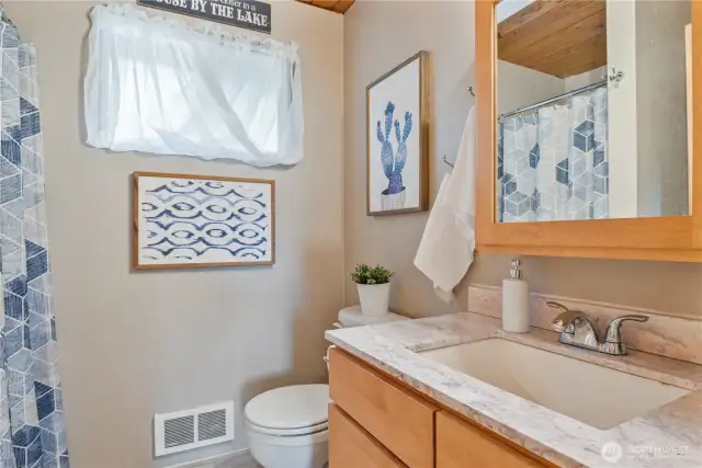 Bathroom with newer vanity and solid surface countertop