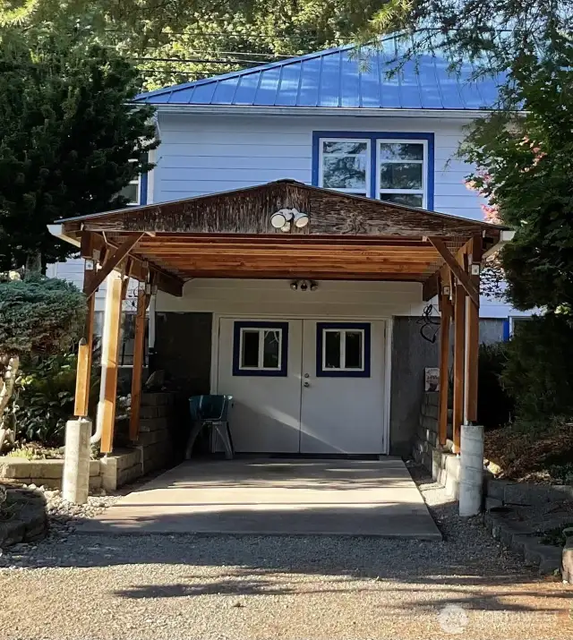 French door  opening from carport/ garage into lower level