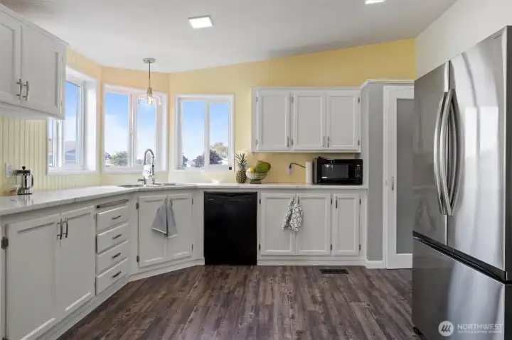 Spacious kitchen with beautiful granite countertops. The room features ample storage and is perfect for entertaining.