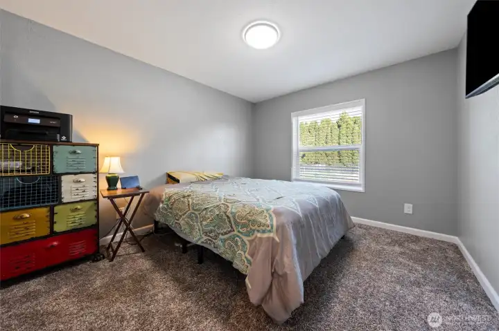 Spacious 3rd bedroom with ample natural light and comfortable space for relaxation or work.