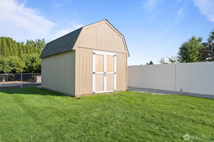 The backyard boasts a substantial shed built on concrete, complete with a loft – ideal for storing gardening equipment and offering additional storage solutions.