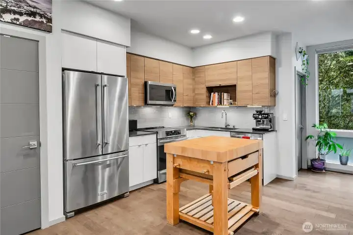 Open concept kitchen with stainless steel appliances and stone counters