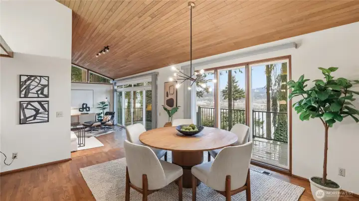 Floor to ceiling glass slider effortlessly brings entertaining to outdoor deck.