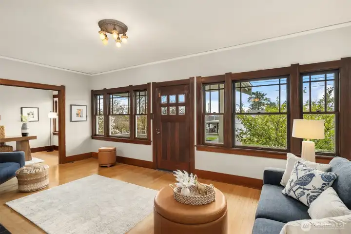 Elegant living room with inviting fireplace and lot of great light from a wall of windows facing south