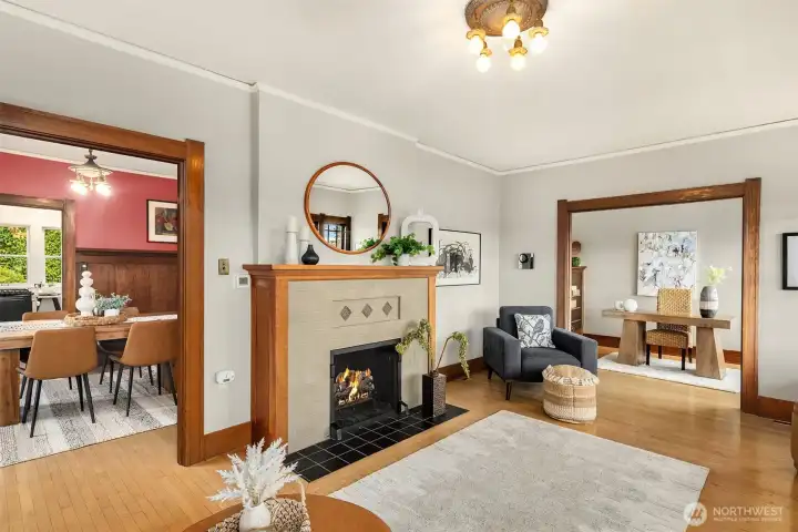 Elegant living room with inviting fireplace and spacious den-office, and access to the gorgeous formal dining room