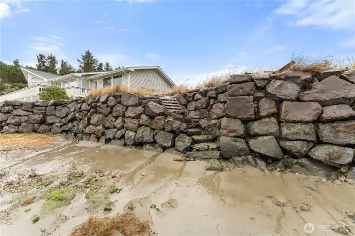 Convenient stairs lead from the bulkhead down to the sandy beach.