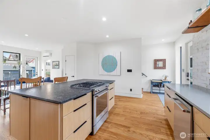 Plywood cabinets with soft-close drawers and quartz countertops. Custom tile walls with solid fir display shelf and window sill