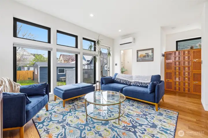 Living room with large windows to let in the light.  Custom blinds for privacy.
