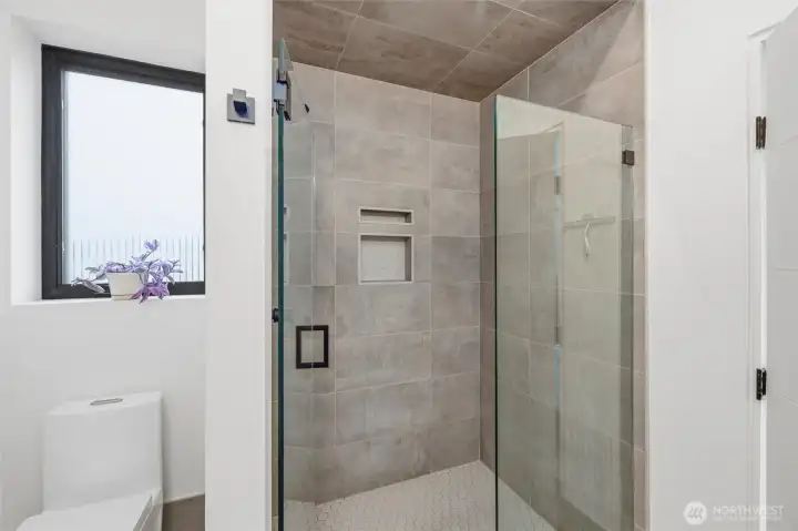 Tiled shower in primary bath and there are also heated tile floors.