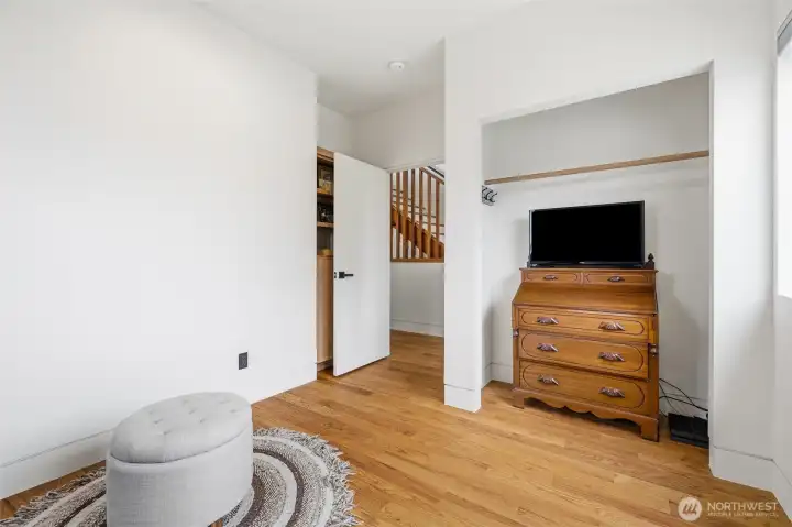 The bedroom includes a built-in cabinet and shelves.