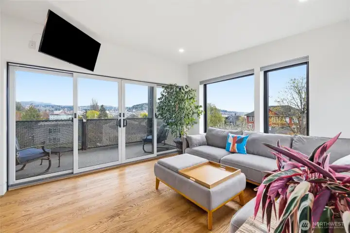 Third floor family room with large windows and sliding glass doors to enjoy the expansive views.