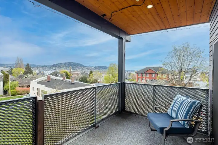 Covered deck with finished wood ceilings, a ceiling heater and lighting.