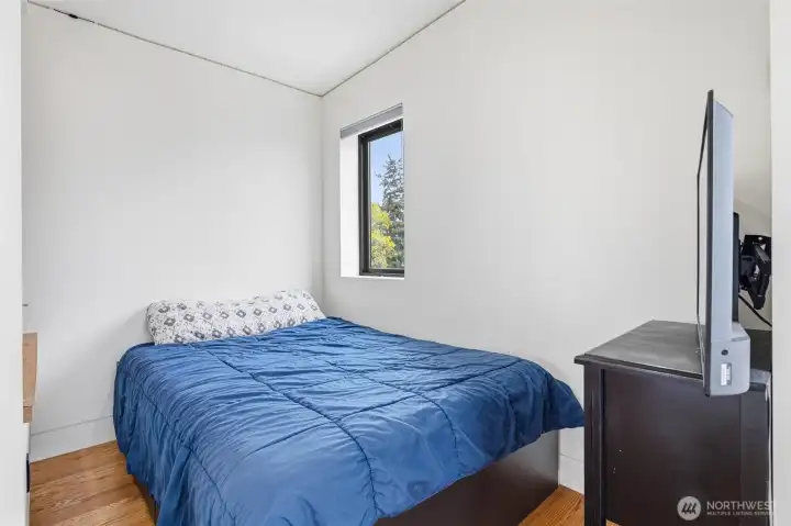 Another view of the bedroom with another window.