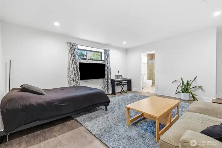 Basement recreation room with plumbing for a wet bar below the window.