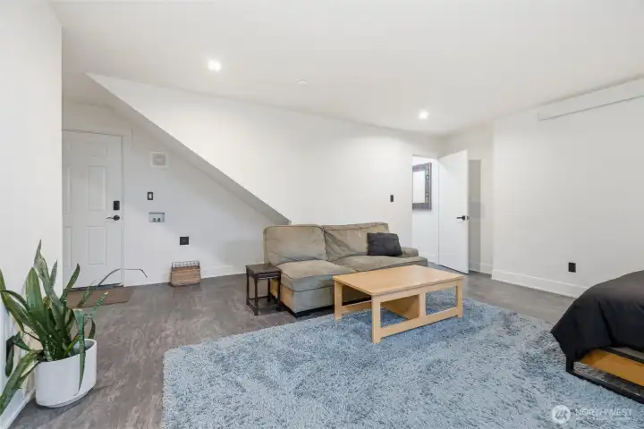 Recreation room showing exterior access door and additional washer/dryer hook up.