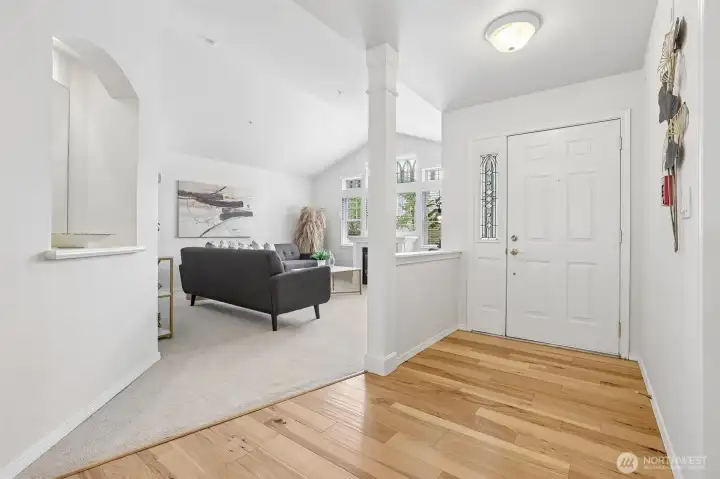 Living room with vaulted ceilings is right off the foyer