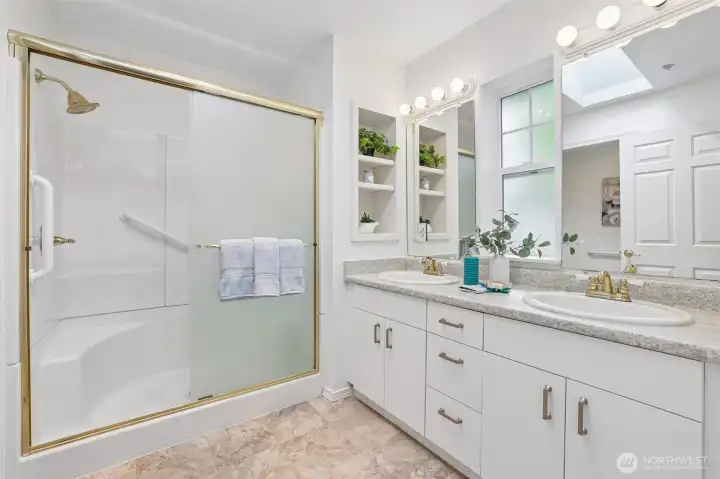 Primary bathroom with skylight and step in shower