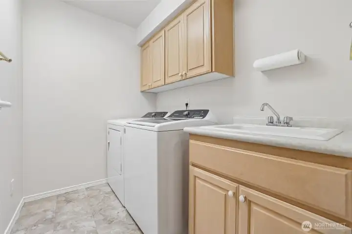Side by Side washer & dryer with utility sink.