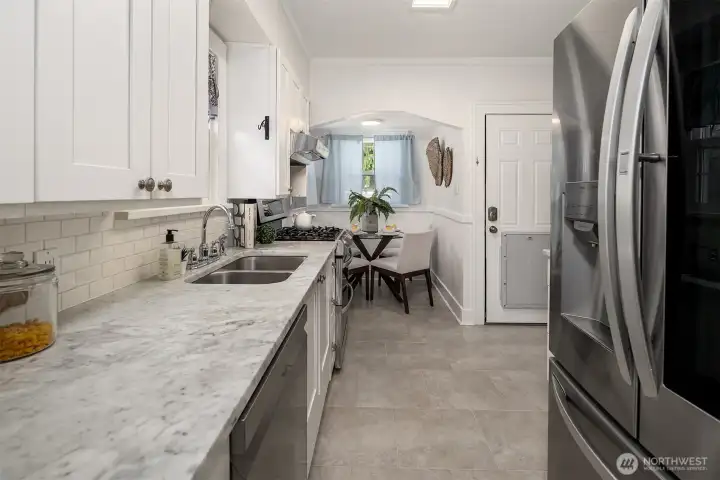 Cute Updated Kitchen with Marble Countertops and a spot to have a 2nd dining space