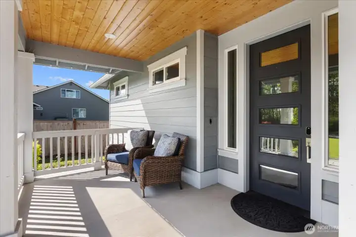 Covered front porch offering a comfortable space to relax and enjoy the surroundings.