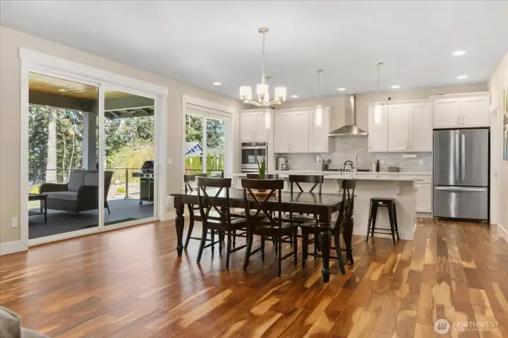 Dining area positioned next to an oversized sliding glass door for effortless indoor-outdoor flow.