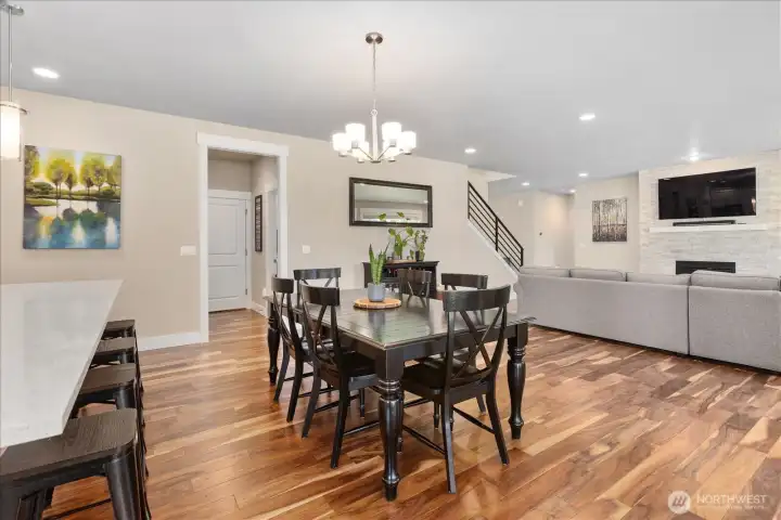 Defined dining space with modern lighting and direct sightlines to the living area.