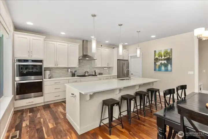 Functional layout with generous prep space, island seating, and pendant lighting that enhances the overall design.