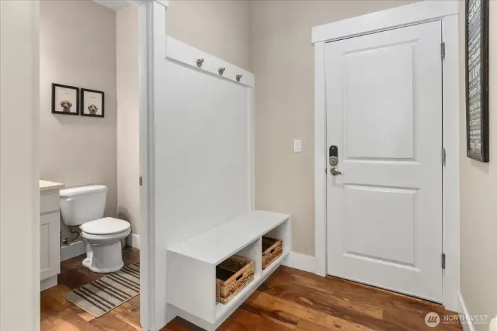 Built-in seating and storage off the garage, ideal for everyday organization.