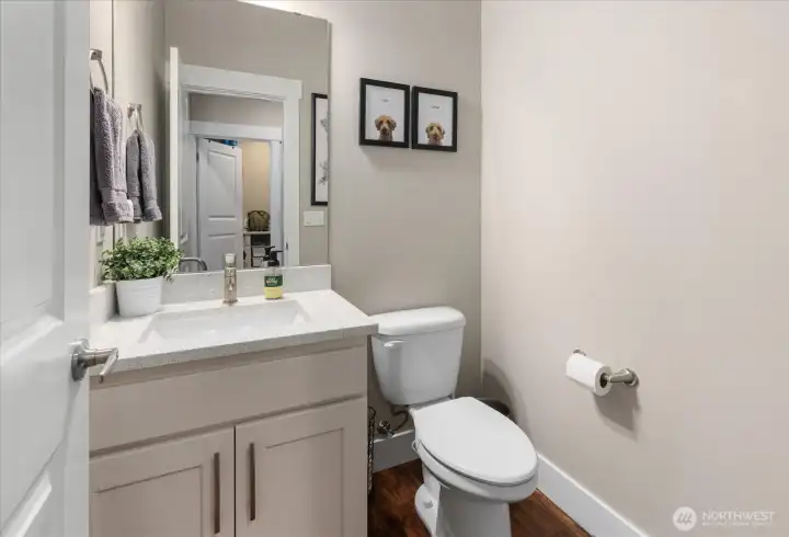 Main-level powder room with quartz countertop and clean, modern finishes.